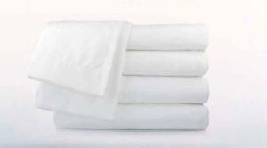 Folded white T400 collection towels for hotels, healthcare, and hospitality use